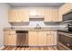 A well-lit kitchen featuring wooden cabinets, granite countertops, and stainless steel appliances at 328 Bentley Pl # 328, Tucker, GA 30084