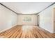 A spacious living room with hardwood floors, neutral paint, and a large window for natural light at 328 Bentley Pl # 328, Tucker, GA 30084