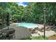 A beautiful pool surrounded by lush greenery and plenty of lounge chairs at 328 Bentley Pl # 328, Tucker, GA 30084
