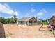 Back of house with enclosed patio and large lot with swing set is great for Gathering fun at 569 Lovell Rd, Temple, GA 30179