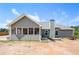 Back of house features an enclosed patio and large lot with lawn mower at 569 Lovell Rd, Temple, GA 30179