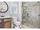 Bathroom features a vanity, toilet, and glass enclosed shower with gray stone tile at 569 Lovell Rd, Temple, GA 30179