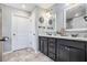 Bathroom boasts double sinks, a black vanity, white marble countertops, and modern fixtures at 569 Lovell Rd, Temple, GA 30179