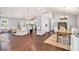 Bright dining area with hardwood floors, a wooden dining table, and a window view, creating a warm atmosphere at 569 Lovell Rd, Temple, GA 30179