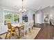 Inviting dining area with hardwood floors, a wooden dining table, and natural light, perfect for Gathering meals at 569 Lovell Rd, Temple, GA 30179