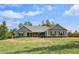 Charming single-story home with a well-maintained lawn and inviting front porch on a sunny day at 569 Lovell Rd, Temple, GA 30179