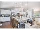 Open kitchen and eat in dining area featuring a large island with granite countertops and pendant lighting at 569 Lovell Rd, Temple, GA 30179