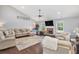 Cozy living room featuring hardwood floors, a stone fireplace, and large windows for a warm and inviting atmosphere at 569 Lovell Rd, Temple, GA 30179
