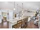 Open living space and kitchen area featuring a large island with granite countertops and hardwood floors at 569 Lovell Rd, Temple, GA 30179