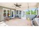 Enclosed patio features a ceiling fan, chairs, and a swing for enjoying the outdoors at 569 Lovell Rd, Temple, GA 30179