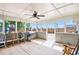 Covered patio with ceiling fan, chairs, and grill is ideal for outdoor entertaining at 569 Lovell Rd, Temple, GA 30179