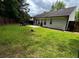 Grassy backyard featuring a patio and bordered by a privacy fence and mature trees at 7113 Silver Mine Xing, Austell, GA 30168