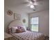 Bright bedroom featuring a ceiling fan, a comfortable bed, and natural light from the window at 7113 Silver Mine Xing, Austell, GA 30168
