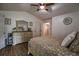 This is a bedroom, with a bed, wooden floors, high ceilings, a ceiling fan, and a light-colored dresser at 7113 Silver Mine Xing, Austell, GA 30168