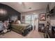 Inviting bedroom with dark paneling, window light, carpet, ceiling fan, and comfortable decor at 7113 Silver Mine Xing, Austell, GA 30168