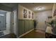 Beautiful foyer featuring decorative wainscoting, hardwood floors, and bathroom access at 7113 Silver Mine Xing, Austell, GA 30168