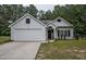 Charming single-story home with a well-manicured front yard and attached two car garage at 7113 Silver Mine Xing, Austell, GA 30168