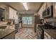 Charming kitchen with stainless steel appliances and herringbone tile floors at 7113 Silver Mine Xing, Austell, GA 30168