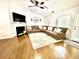 Cozy living room featuring hardwood floors, a fireplace, and a comfortable brown sectional sofa at 7113 Silver Mine Xing, Austell, GA 30168