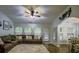Spacious living room featuring a plush sectional couch, ample natural light, and seamless dining area access at 7113 Silver Mine Xing, Austell, GA 30168