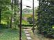 An exterior view of a multi-story home surrounded by mature trees and landscaping at 1233 Woodland Ne Ave # 5, Atlanta, GA 30324