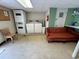 A laundry room with a washer, dryer, lounge sofa, and utility sink at 1233 Woodland Ne Ave # 5, Atlanta, GA 30324