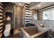 Modern bathroom with tiled walls, glass shower, soaking tub, and sleek fixtures at 285 Centennial Olympic Park Nw Dr # Ph2-7, Atlanta, GA 30313