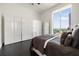 Modern bedroom with large windows and city views, featuring a sleek wardrobe and dark floors at 285 Centennial Olympic Park Nw Dr # Ph2-7, Atlanta, GA 30313