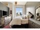 A modern suite featuring a large bed and dresser with skyline views at 285 Centennial Olympic Park Nw Dr # Ph2-7, Atlanta, GA 30313