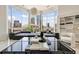 Modern living room featuring a large window with stunning city views and contemporary decor at 285 Centennial Olympic Park Nw Dr # Ph2-7, Atlanta, GA 30313