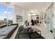 Bright, open living space with modern furniture, a unique bookshelf, and sliding glass doors at 285 Centennial Olympic Park Nw Dr # Ph2-7, Atlanta, GA 30313