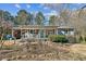 Charming single-story home featuring a cozy front porch with chairs and well-maintained landscaping at 315 Charlotte Blvd, Stockbridge, GA 30281