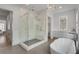 Modern bathroom featuring a soaking tub, frameless shower, and marble accents at 574 Boulevard Ne Pl # 4, Atlanta, GA 30308