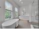 Bright bathroom features a freestanding tub, frameless shower and modern fixtures at 574 Boulevard Ne Pl # 4, Atlanta, GA 30308