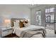 Comfortable bedroom with white brick accent wall and access to a private balcony at 574 Boulevard Ne Pl # 4, Atlanta, GA 30308
