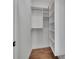 Walk-in closet with custom shelving, hanging racks, and hardwood floors at 574 Boulevard Ne Pl # 4, Atlanta, GA 30308