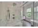 Elegant shower with dual shower heads, bench, and marble tile surround at 574 Boulevard Ne Pl # 4, Atlanta, GA 30308