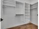 Spacious walk-in closet featuring built-in shelving, rods and hardwood floors at 574 Boulevard Ne Pl # 4, Atlanta, GA 30308