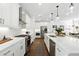 Modern kitchen featuring white countertops, stainless steel appliances, and pendant lighting, creating a stylish cooking space at 116 Birch Tree Way, Cumming, GA 30040