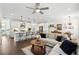 Open-concept living room showcases a seamless transition into the kitchen, featuring modern finishes and ample natural light at 116 Birch Tree Way, Cumming, GA 30040