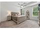 Spacious main bedroom with a tray ceiling, plush carpeting, and windows offering a view of the outdoors at 116 Birch Tree Way, Cumming, GA 30040