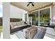 Relaxing covered patio featuring an outdoor seating area with fireplace and ceiling fan at 116 Birch Tree Way, Cumming, GA 30040