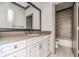 Stylish bathroom featuring a vanity with a dark countertop, large mirror, and tub with tiled backsplash at 1435 Druid Manor, Atlanta, GA 30329