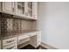 Chic office area with granite counter, tiled backsplash, and white cabinets for storage at 1435 Druid Manor, Atlanta, GA 30329