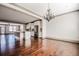 Open concept living space with gleaming hardwood floors, kitchen, and chandelier at 1435 Druid Manor, Atlanta, GA 30329