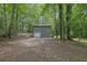 View of a private backyard with a garage and parking area at 361 Gordon Valley Sw Ln, Mableton, GA 30126