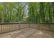 View of the spacious wooden deck overlooking the wooded backyard at 361 Gordon Valley Sw Ln, Mableton, GA 30126