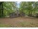 Exterior back view of the home with a large backyard surrounded by trees at 361 Gordon Valley Sw Ln, Mableton, GA 30126