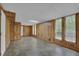 A large basement with paneled walls, drop ceiling, vinyl floors, and several windows at 361 Gordon Valley Sw Ln, Mableton, GA 30126