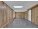 A blank canvas basement with paneled walls, a drop ceiling, and a simple floor at 361 Gordon Valley Sw Ln, Mableton, GA 30126